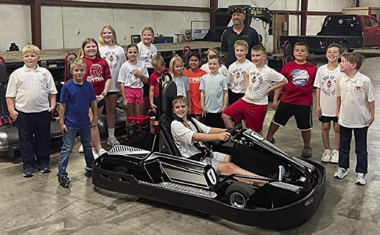 St. Rose Science Club members who visited American Kart Manufacturing (formerly Shaller Enjuneering) included (front, in go-kart) Levi Johnson, (standing, from left) Wyatt Smrkovsky, Hagan Holub, Emma McCourt, Brenley Berger, Addison Johnson, Zoey Krenek, Miles Krenek, Adriana Leihardt, Rebeca Camacho, Claire McCourt, Cason Hale, Brennen Berger, Braydon Rainosek, Bentley Bubela, Brody Lewis and Hudson Novick. Standing behind the group is Greg Vrana, general manager at the facility.