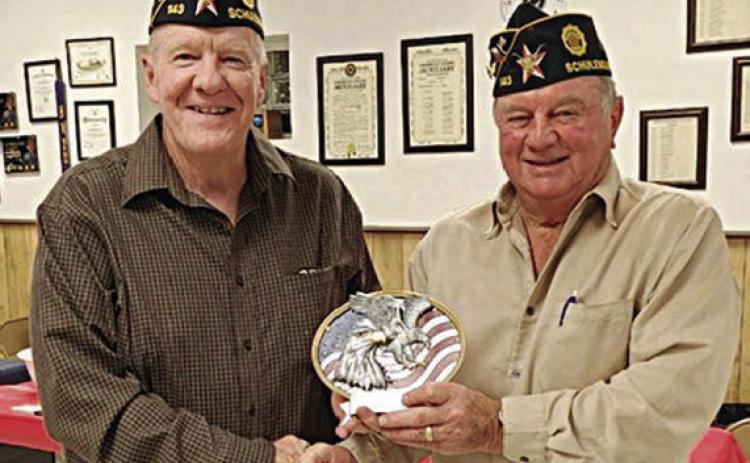 Post 143 Commander Bob Heinrich (right) presents the 2023 Legionnaire of the Year Award to C. W. Leonard.