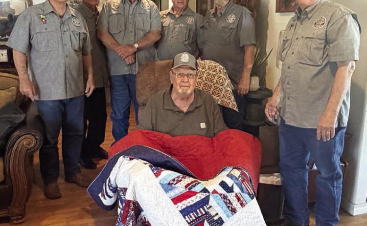 John Dodson (front), Vietnam veteran who served in the U.S. Army, was recently presented a Quilt of Valor by Vietnam Veterans of America Chapter 870. Dodson was not only a founding member and original officer of VVA Chapter 870 but is also a retired teacher in Schulenburg. Delivering the quilt to Dodson were VVA 870 members (back row, from left) Don Christen, Eugene Krupala, Daniel Kutac, Frank White, Gerald Smith and Andy Janda.