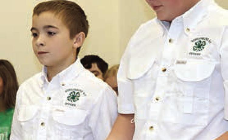 Gage Smrkovsky (left) and Abraham McBride present the report of the Schulenburg 4-H activities over the past year to the Commissioners Court. Photo By Melanie Berger / Courtesy of Flatonia Argus