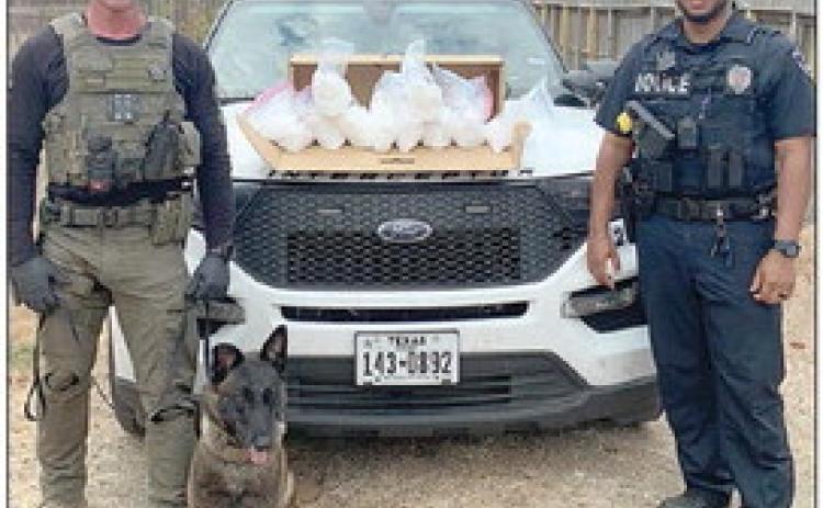 Officers shown with the seized methamphetamine are Interdiction Sgt. Randy Thumann (left) with K-9 partner, Kolt, and Schulenburg Police Officer Byron Powe (right).