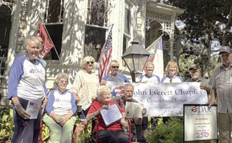 Bob and Nancy Stiles (front, holding certificates) feel that flying the American flag shows pride in this country. They also fly the Texas flag and the Columbus Cardinals flag. DAR/SAR representatives shown are (back row, from left) Judy Zachmeyer, Glen Strey (behind Zachmeyer), Nelma Strey, Connie Dittrich, Marti Herring, Donna Pustejovsky, Stephanie and Rick Mattix, and Dave Zachmeyer.