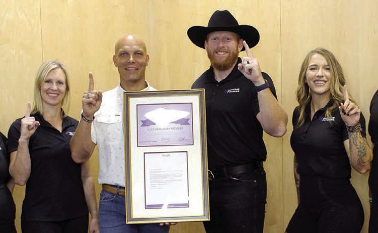Displaying the Club Purple status received by Anytime Fitness in Schulenburg are (from left) Amanda Brown, club manager; Kim Bubela, owner/ trainer; Chip Bubela, owner; Mitchell Bailey, owner/regional manager; Lauren Ralph, head trainer; and Abe Centeno, trainer.