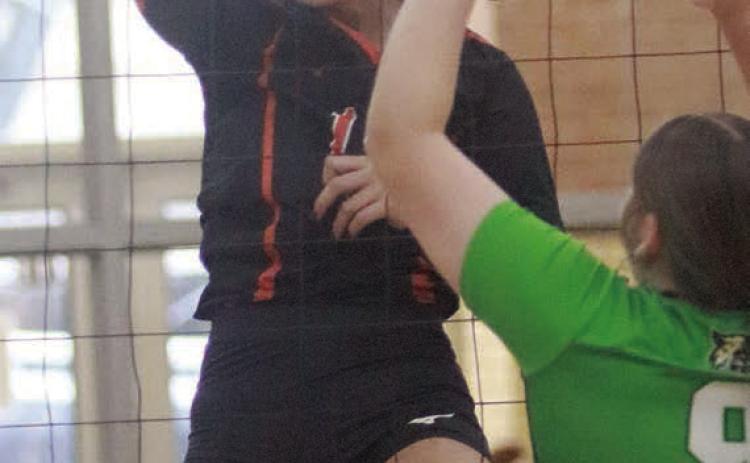 Kimber Bartosch rifles a kill past a Hempstead player in the second set. Sticker Photo By Darrell Vyvjala