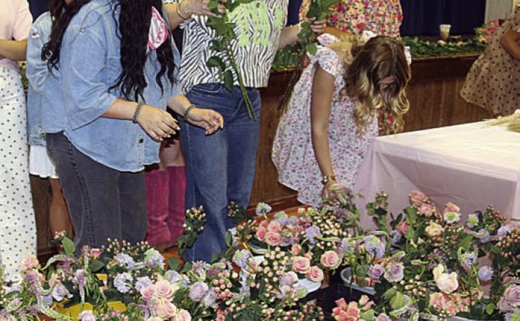 Schulenburg FFA students prepare the containers for the afternoon competition during its first Petal Revival. Sticker Photo By Darrell Vyvjala