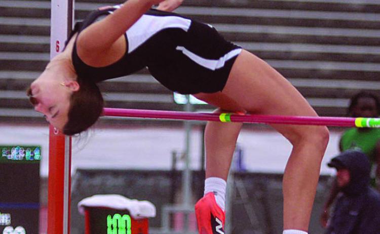 Meredith Magliolo gets over the bar at 5-feet, 4-inches at the state meet last Friday on her third attempt. Sticker Photo By Darrell Vyvjala