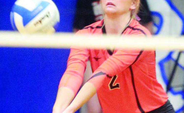 Miranda Bonner picks up a dig in the first set against Rice Consolidated. Sticker Photo By Darrell Vyvjala