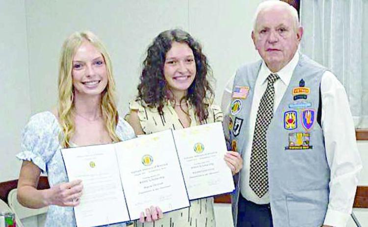 Presenting the scholarships to Alyssa Zbranek (left) and Natalie Osina (center) was Leonard Sternadel (right) representing VVA Chapter 870.
