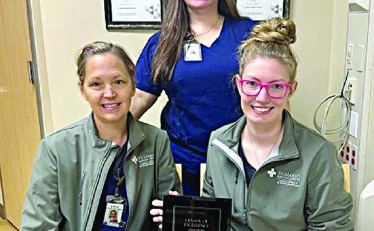 Displaying the Restorix Health clinical distinction award is the St. Mark’s Advanced Outpatient Wound Center team of (front row, from left) Stacie Schramek, RN; Jackie Faigle, FNP-C; and (back) Jennifer Scott, RN, program director. The team is one of only 26 in the US to achieve the goals in wound healing rates and safety.