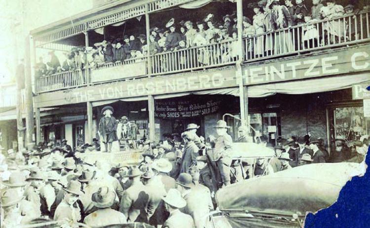 A large crowd gathered in front of the Von Rosenberg-Heintze Company at 345 and 353 West Travis St. in La Grange on March 5, 1908, to see Buster Brown and his dog pal, Tige. August Heintze is the bearded man on the balcony. – Photo courtesy of Fayette Heritage Museum &amp; Archives, La Grange