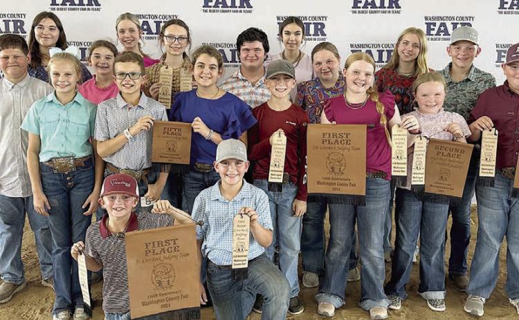Fayette County 4-H’ers participating in the Washington County Livestock Judging Contest were (front row, from left) Joseph Carrales, Hudson Holub, (second row) Cailee Daniel, Tate Fritsch, Adalyn Carrales, Crockett Guenther, Kaisley Janecka, Abigale McBride, Abraham McBride, (third row) Hunter Gabler, Laramie Laake, Tatum Fritsch, Logan Poncik, Brealey Nieto, Peyton Gilchrest, Holden Holub, coach Kaci Carrales, (back row) coach JoJo Carrales, Addison Eichler, Hailey Janish and Tori Newton.