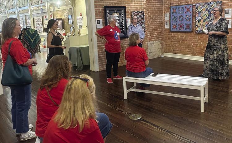 (standing, from left) Lisa Slinkard, a museum visitor from California, Terri Wagner, Kim Joost, Deborah Blanchette Bradley-museum managing director, (seated, back bench) Susie Grider, (seated, front bench, from left) Kim Bonewald and Donna Burton.