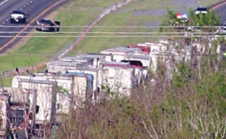 I-10 westbound traffic backs up during the standoff west of Schulenburg Thursday morning. Sticker Photo By Darrell Vyvjala