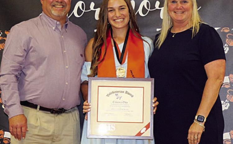 Tamara Otto (center) accepts the valedictorian plaque at the Senior Scholarship Banquet earlier this month with her parents, Keith and Stacy Otto. Photo By Audrey Kristynik