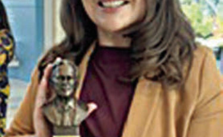 Nicole Gabler shows off the A&amp;M Outstanding Alumni/Former Student of the Year Award she received.