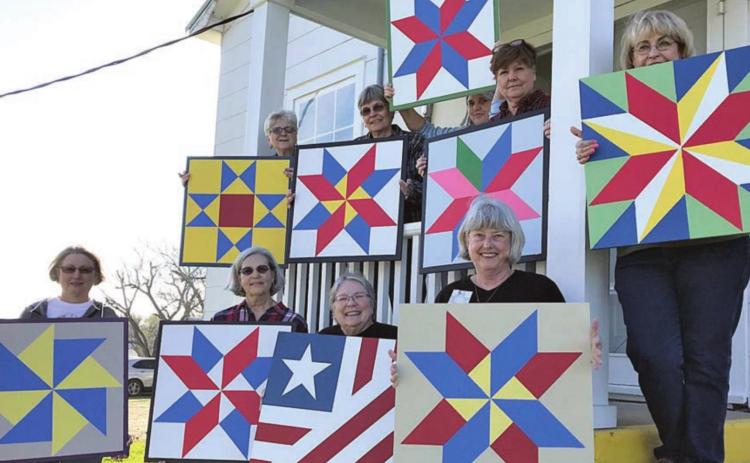 Students in a quilt block painting class in Winchester display their creations. A similar class will be held Friday at the Blinn College-Schulenburg Campus.