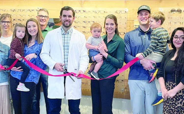 Shown are (from left) Nina Howard, Carrie Schulz, Diana Mikesky, Renee Mikesky, Aubrey Hentges being held by Shannon Hentges (optician at the clinic), Shawn Mikesky, Dr. Kaden Andre, Brady Andre being held by Dr. Leah Mikesky, Hale Hentges holding Ezra Hentges, Amanda Blackburn (front desk staff at the clinic), Paul Zapalac and Ann McBride. Sticker Photo By Darrell Vyvjala