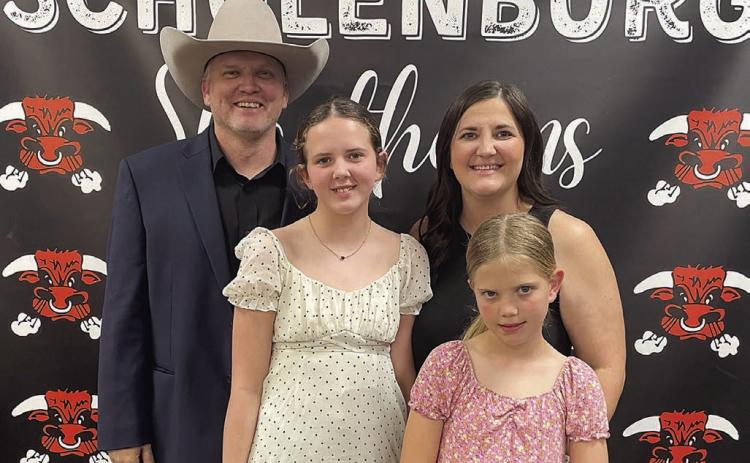 New SISD Athletic Director Clay Ferguson (left) is shown with his wife, Stephanie (back, right), and two daughters – 12-year-old Paisley (front, left) and 9-year-old Hadley (front, right) – following the Board of Trustees’ unanimous vote on his hiring last Friday. Sticker Photo By Darrell Vyvjala