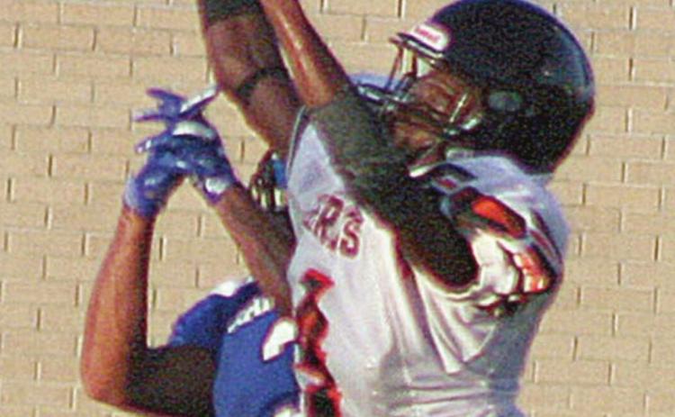 Kenny King skies to break up a pass in last Thursday's scrimmage. Sticker Photo By Darrell Vyvjala