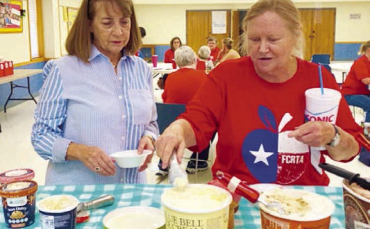 Enjoying ice cre am with a variety of topping at the FCRTA social were Patty Ehler and Donna Burton.