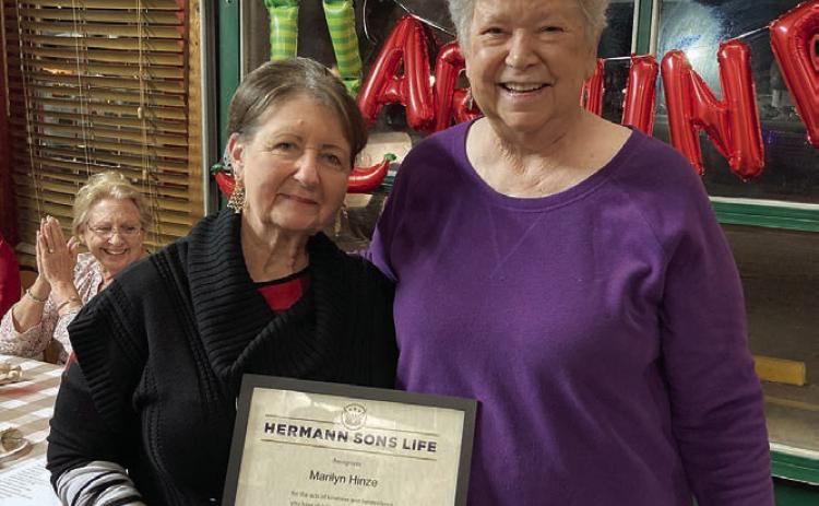 Marilyn Hinze (left) accepts the Humanitarian of the Year Award from Junette Rodecap, who serves as chair of the award committee for Hermann Sons Life.