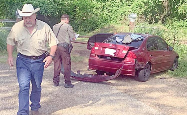 Sheriff Keith Korenek and Deputy Michael Krenek are shown with the vehicle involved in Monday’s pursuit.