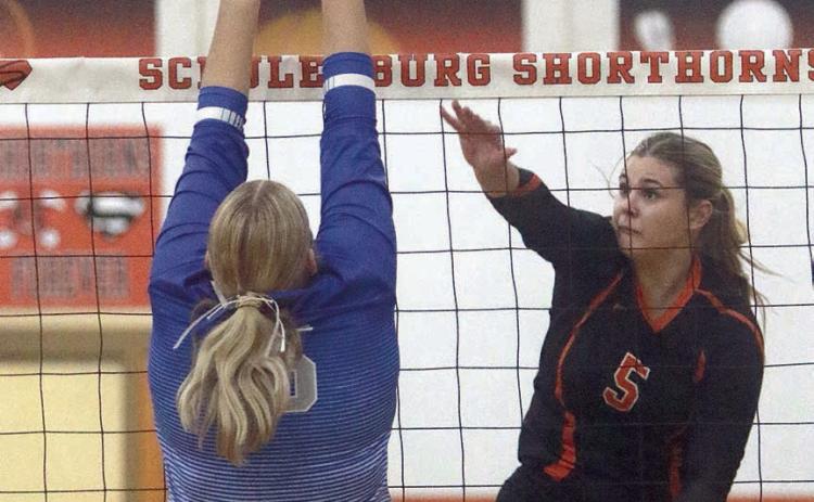 Haylee Vacek knocks a kill cross-court in the third set against Rice Consolidated. Sticker Photo By Darrell Vyvjala