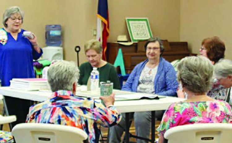 TOP PHOTO – Annie McHugs conducting a Picture Windows Reverse Applique workshop for the Colorado Valley Quilt Guild.