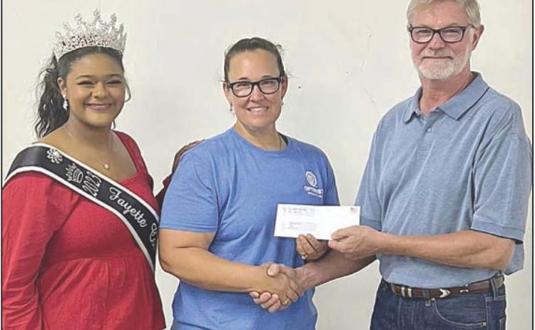 LA GRANGE OPTIMIST CLUB received a donation of $2,964.50. Shown are (from left) Queen Harper Henneke, Optimist Club representative Misty Nox and Fair president Mike Zuhn.