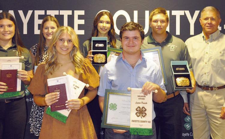 Senior Division Awards – (front row, from left) Addison Faske, “I Dare You” Award; Logan Poncik, Silver Star  Award; (back row) Madeline Willrich, “I Dare You” Award; Elena Supak, Silver Star Award; Tori Newton, Gold Star Award;  Railey Nieto, Gold Star Award; and presenter Commissioner Harvey Berckenhoff.