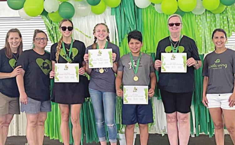 FUN RUN WINNERS – (from left) DeeAnn Hooper (Turtle Wing Foundation founder), Kim Wellborn (Turtle Wing Foundation Board member), Kari Cristen (Women’s Division winner), Reagan Moreau (Girls’ 17u Division winner), Lucas Moreno (Boys’ 17u Division winner), Becky Garlick (Not Fast, But Fabulous Award), and Kari Tumis (Turtle Wing Foundation Board member).