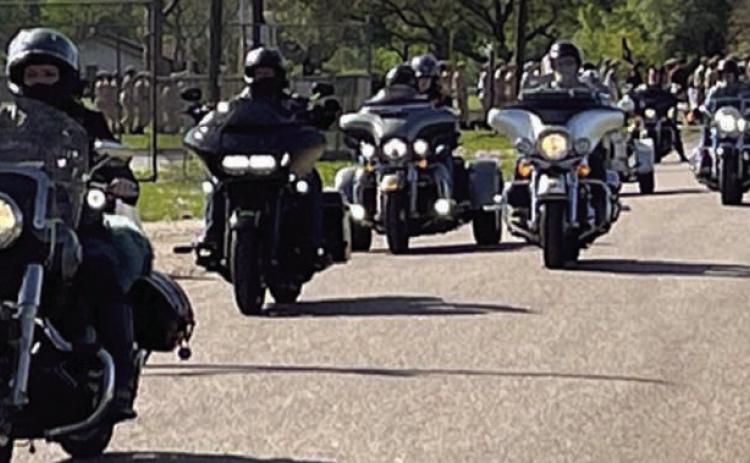 American Legion Riders from Benbrook Post 297, Schulenburg Post 143 and Sealy Post 442 lead cadets from Texas ChalleNGe Academy in Eagle Lake in a parade march to their families on family day at Nada Community Center.