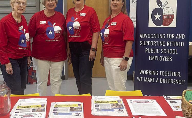 Shown BEHIND the table with materials about the Fayette County Retired Teachers Association are (from left) Karen Fitch, Chris Morrison, Peggy Halamicek and Lisa Slinkard.