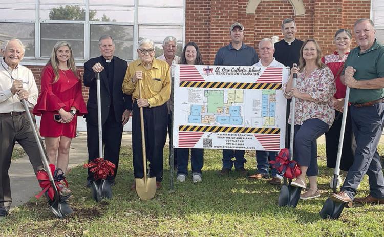 Taking part in the groundbreaking ceremony last week were: (from left) Renovation Committee members Gary Zweschper, Ralph Schmidt, and Taylor Jensen; the Rev. Jasper Liggio, pastor of St. Rose Church; committee member Ted Stanzel; Doug Gaeke of Gaeke Construction; architect Joanna Prihoda; committee members Paddy Magliolo and Jackie Machac; the Rev. Luke Prihoda; St. Rose Principal Rosanne Gallia; and committee members Melissa Schmidt, Eamon Mc-Court, and Adam Besetzny. Sticker Photo By Darrell Vyvjala