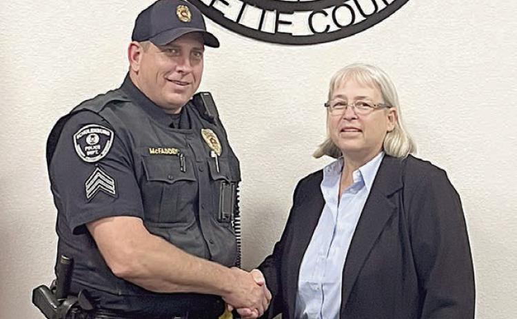 Mayor Connie Koopmann (right) congratulates Sgt. Tobey McFadden on his 10-year anniversary with the City of Schulenburg during Monday night’s City Council meeting. She and the aldermen expressed their appreciation for McFadden’s service to the community. Sticker Photo By Layne Vyvjala