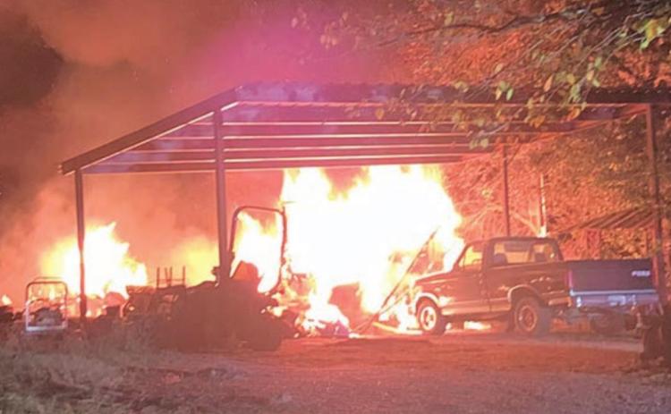 A early-morning fire engulfed two structures on Camp Lone Star Road in La Grange Sunday. Photo Courtesy of Fayette County Sheriff’s Department