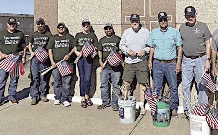 Helping place flags on th e graves of deceased veterans in area cemeteries ahead of Memorial Day were Invenergy staff members, who joined American Legion Post 143 for the annual project. Shown at St. Rose of Lima Catholic Cemetery with Post 143 members are five Invenergy staff from 7V Solar Ranch near Muldoon – (starting second from left) Matt Ray, solar tech; Cody Pruit, manager; Tori Serrato, solar tech; Karen Leighton, administrative assistant; and Art Rahman, solar tech.