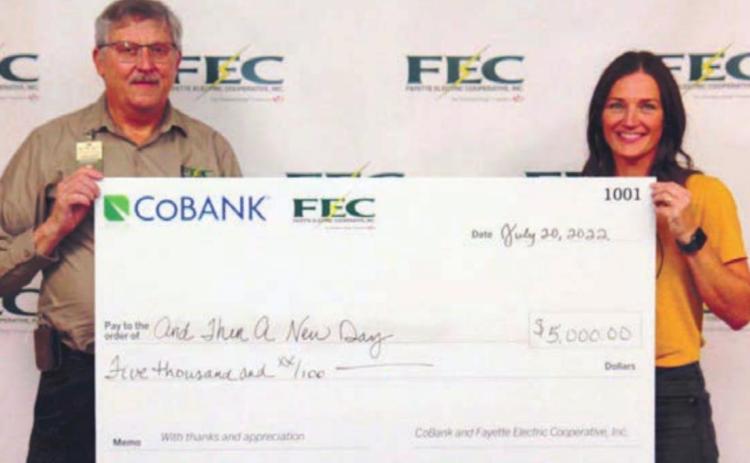 And Then a New Day receiving its $5,000 grant. Shown are (from left) Fayette Electric Cooperative General Manager Gary Don Nietsche; and Erin Wotipka, And Then a New Day executive director.