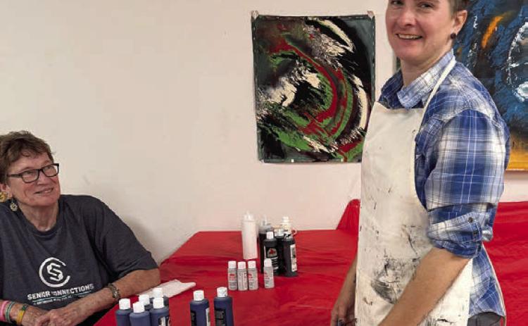 In her painting without brushes class on Artful Friday, Jaime Janda (right) had her group of students breaking out of their comfort zone. Berni Gillings (left) was primed and ready to do something new – she thoroughly enjoys the program.