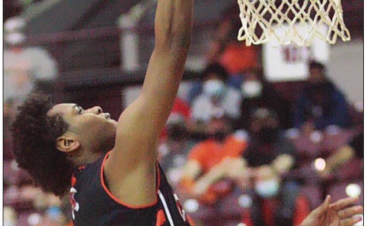 Bryce Wilson soars to the hoop for a score in the third quarter. Sticker Photo By Kade Vyvjala