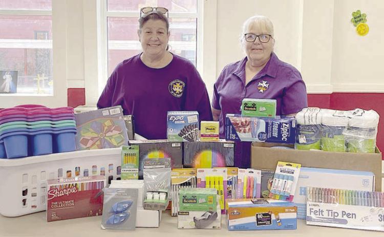 CDA Court St. Rose 1597 regent Grace Lebeda (left) and recording secretary Phyllis Valchar (right) with the school supplies donated to St. Rose of Lima Catholic School.