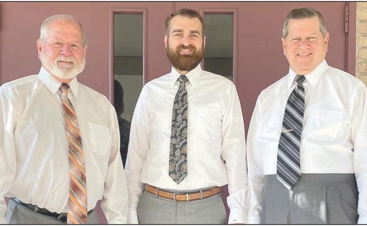 Shown in front of Schwenke-Baumgarten Funeral Home are (from left) Mark, Clayton, and Bryan Klesel. Sticker Photo By Darrell Vyvjala