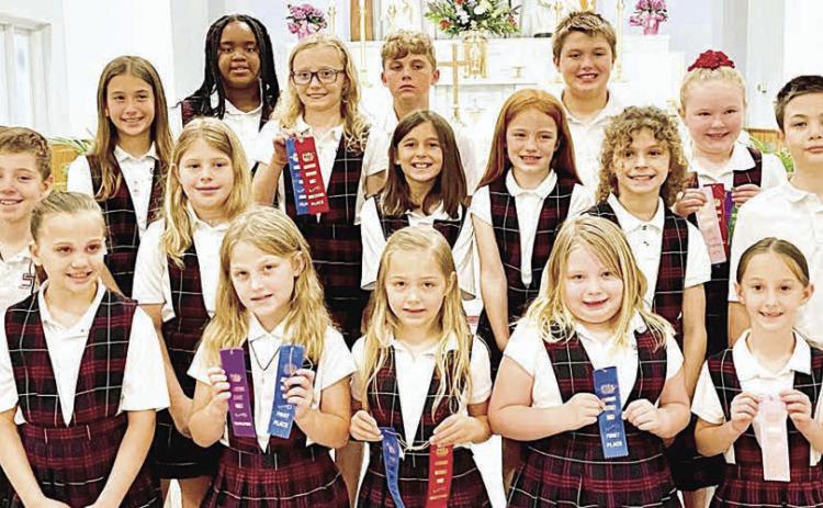 Grades 1-4 Winners – (front row, from left) Addison Johnson, Emileigh Divin, Ellie Klein, Claire McCourt, Ree Lichnovsky, (middle row) Brody Lewis, Brylee Stoever, Emma Zweschper, Rowan Heinrich, Lane Schiffli, Micah Garcia, (back row) Brielle Goedrich, Jade Williams, Penelope Bartek, Jack Schiffli, Noah Heger and Abigale McBride.