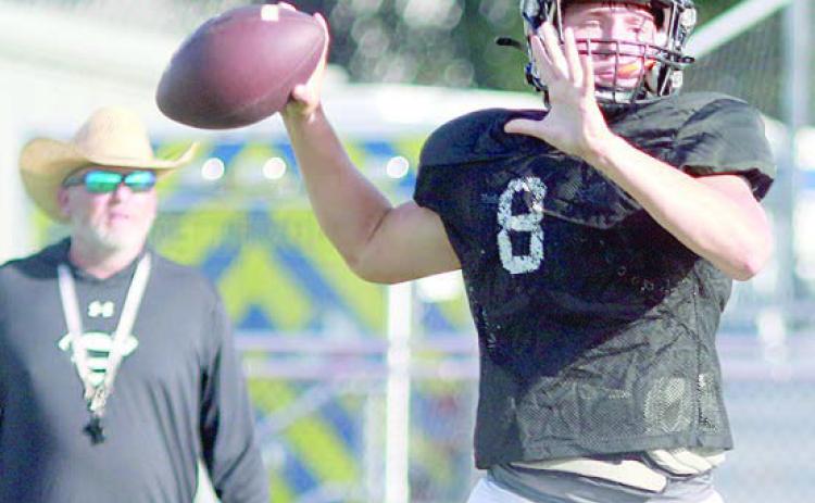 Returning senior quarterback Owen Brenek delivers a pass in the Shorthorns’ first scrimmage last Thursday as head coach Clay Ferguson looks on. Sticker Photo By Darrell Vyvjala