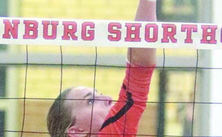 Jenna Guentert tips the ball over for a kill in the fourth set last Tuesday. Sticker Photo By Darrell Vyvjala