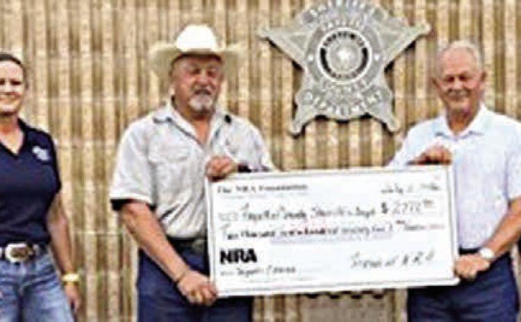 Fayette County Sheriff 's Off ice personnel shown receiving a $2,772.90 grant check from The NRA Foundation and Friends of NRA are (from left) Deputy Herman Olvera, Sgt. Ron Naumann, Sgt. Angela Lala, Sheriff Keith Korenek, Dennis Brower-Friends of NRA, Renee Moreland-FCSO, Lt. David Beyer and Deputy Joe Gonzales.