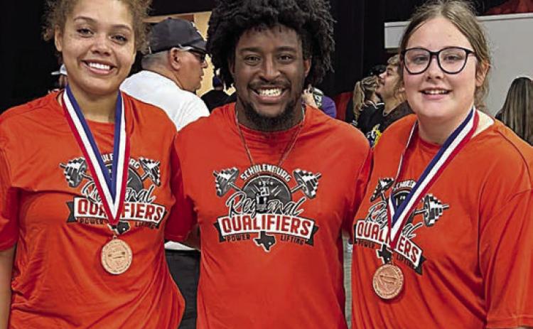 Earning medals at the regional meet were Arianna Vincent ( left) and Cora Brenek (right). They are shown with SHS powerlifting coach Jaylen Samuels.