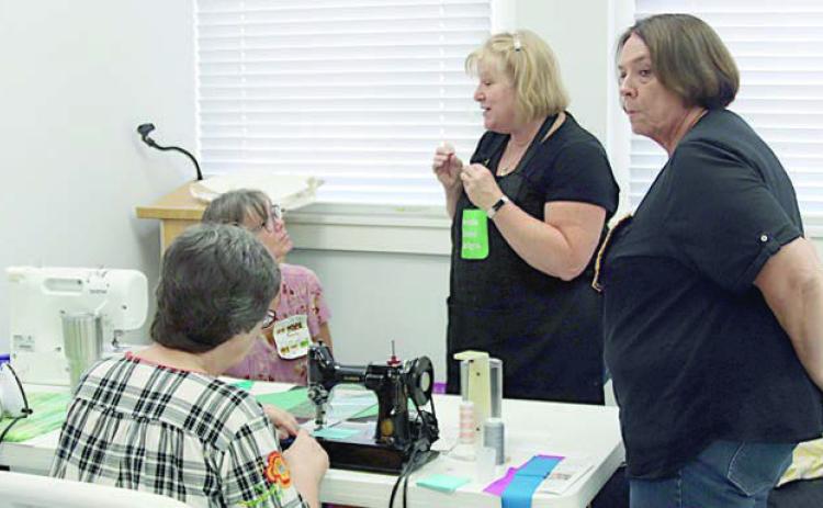 different ways to construct Peaky & Spike quilt blocks were demonstrated by Glenda Wilder (second from right) during a workshop on Aug. 23.