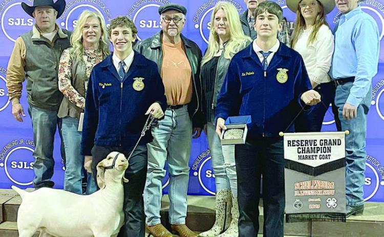 RESERVE CHAMPION MARKET GOAT – Exhibitor: Van Prihoda (front, left). Sales price: $7,200. Sticker Photo By Darrell Vyvjala