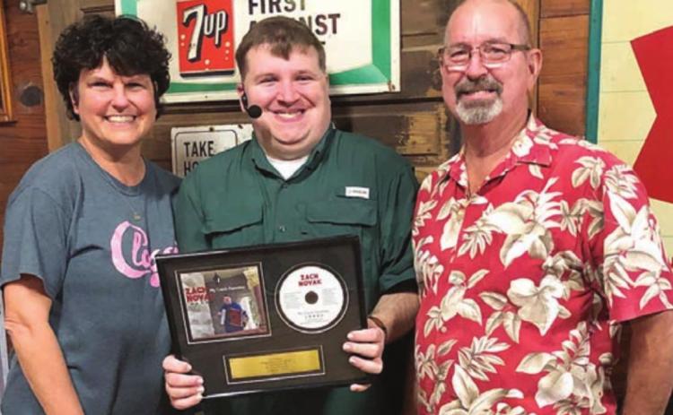 Novak receives plaque